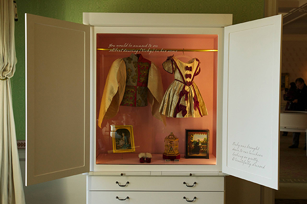 Display case of Queen Victoria children's clothes in the Family Room. The case features outfits worn by Victoria's eldest children - Bertie and Vicky. (c) Historic Royal Palaces